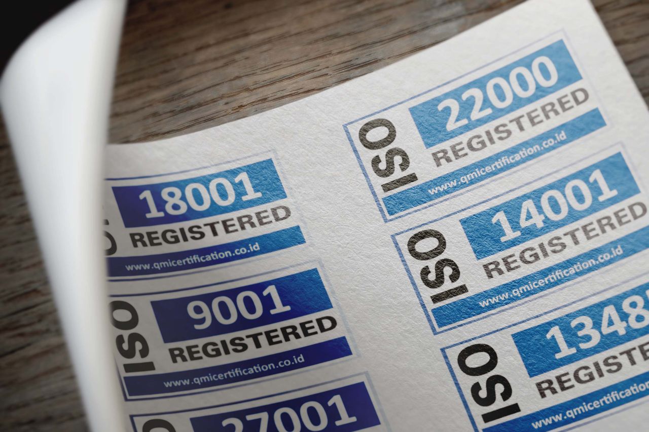 about-01 ISO certification stickers with registration numbers on paper.